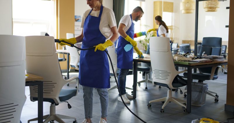 professional-cleaning-service-person-using-vacuum-cleaner-office
